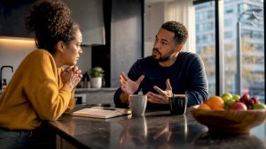 Couple arguing at kitchen table