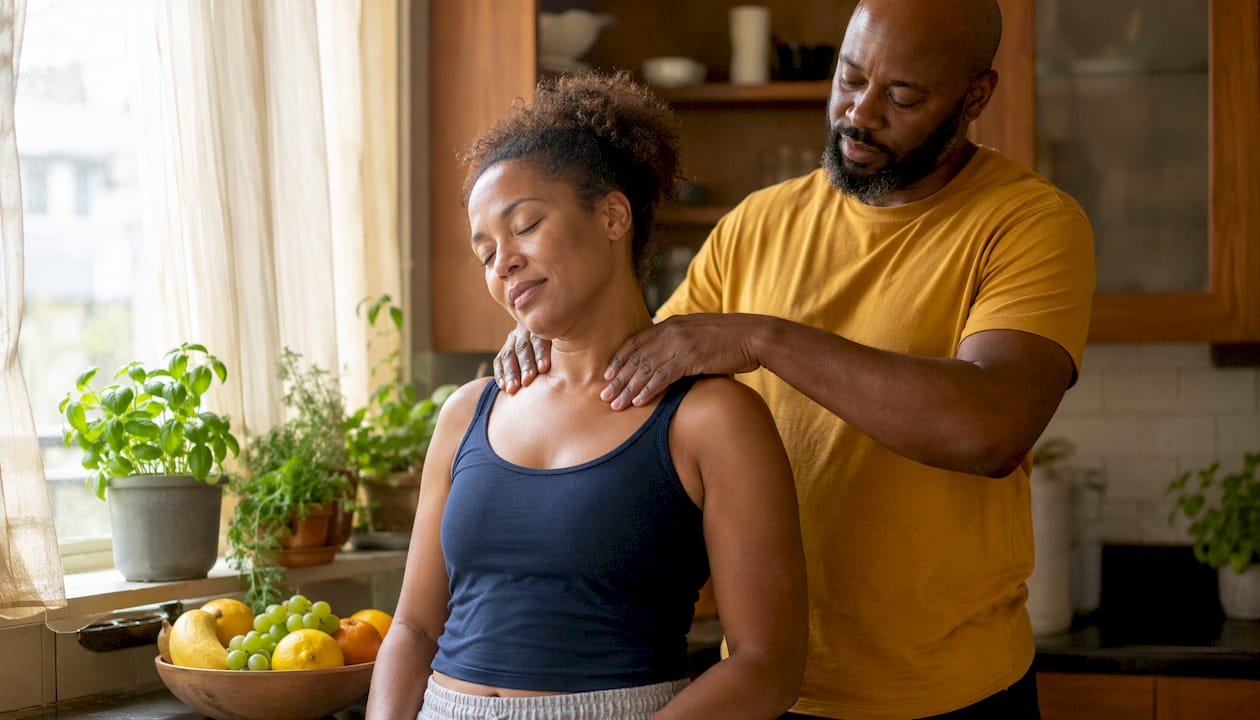 Couple sharing a gentle shoulder massage at home