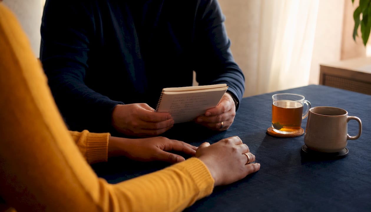 Close-up of partners' hands with notes
