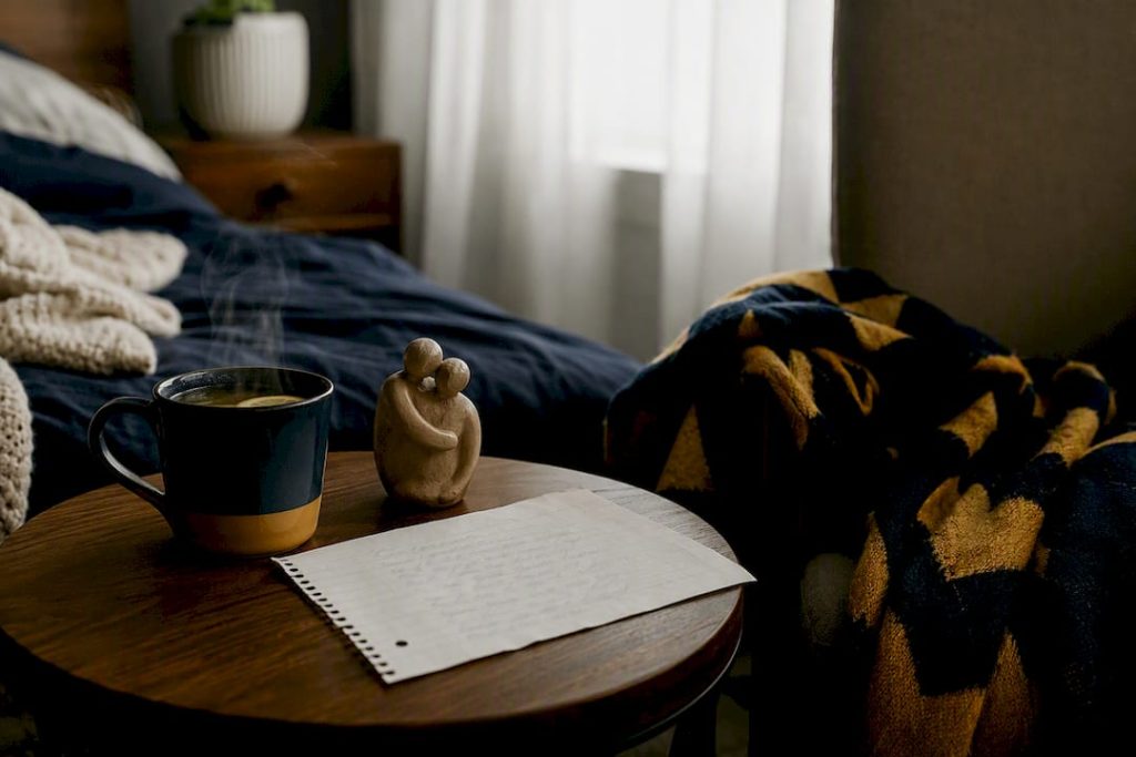 Apology note on coffee table with tea and blanket