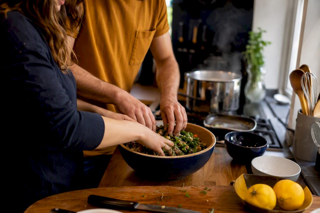 Hands chopping vegetables cooking together